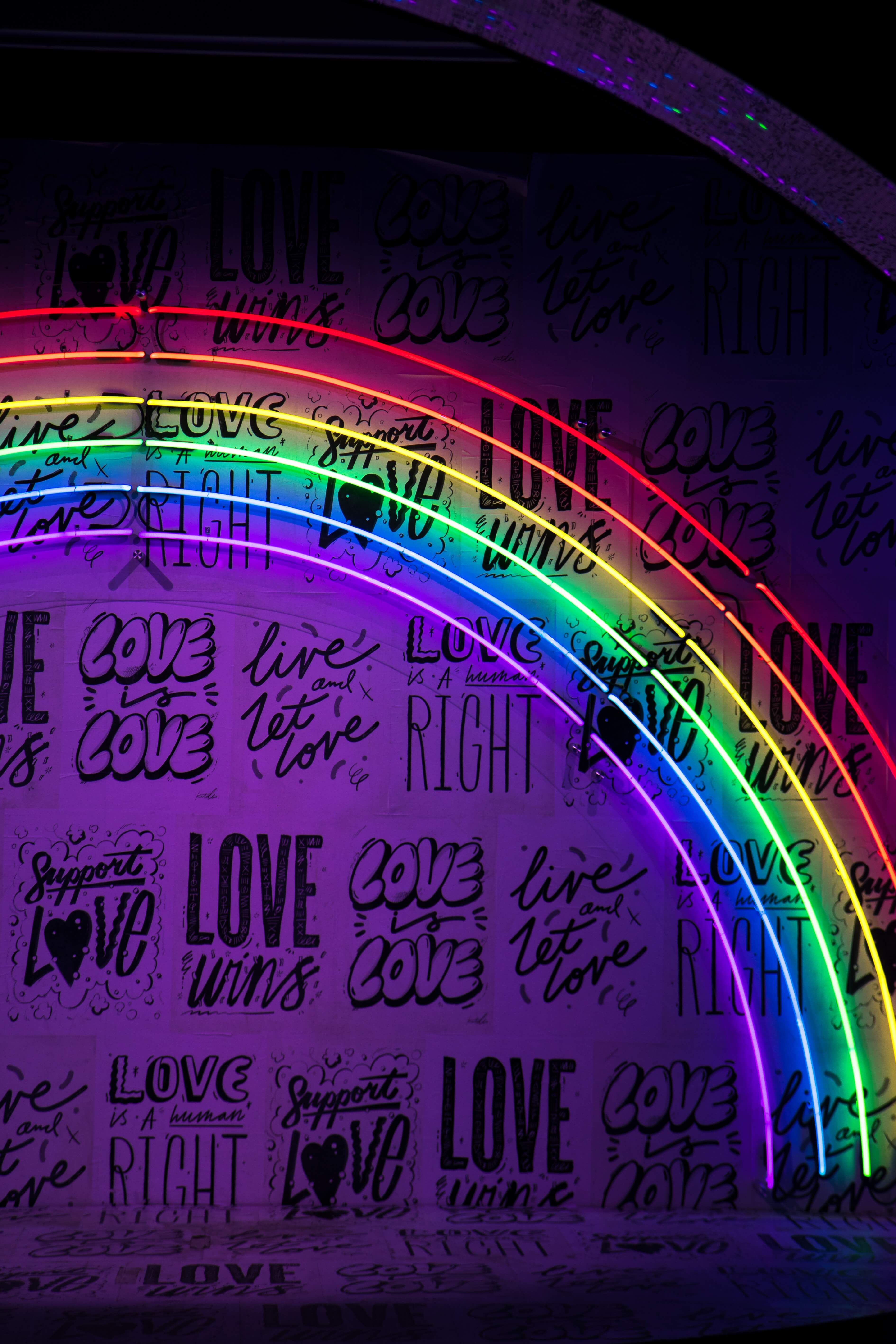 Rainbow ligtning covering a poster with different lgbtq quotes